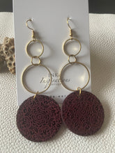 Load image into Gallery viewer, Pair of burgundy engraved wood statement earrings with layered gold-tone hoops
