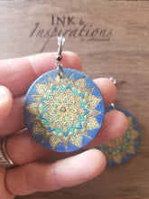 Load image into Gallery viewer, Handmade wood mandala earrings styled for a beach-inspired look
