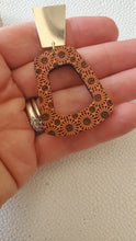 Load image into Gallery viewer, Close-up of Koralyn coral wood hoop earrings showing the patterned wood and brass geometric top
